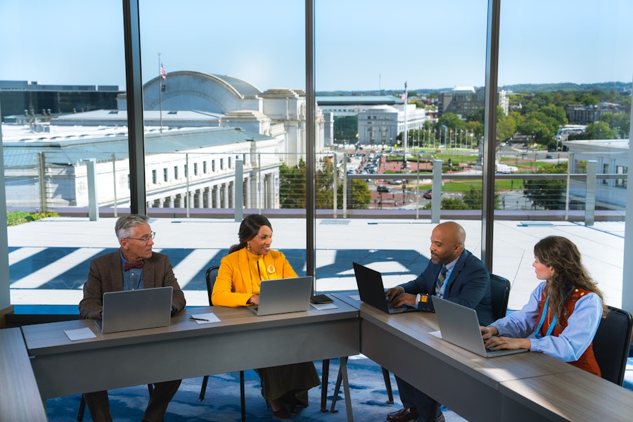 Four people at a meeting looking at Union Station