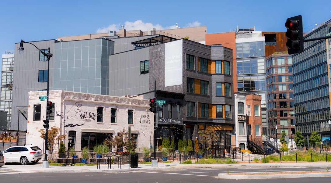Wet Dog Tavern and surrounding modern and historic buildings on a sunny day in the Shaw neighborhood of Washington, DC.