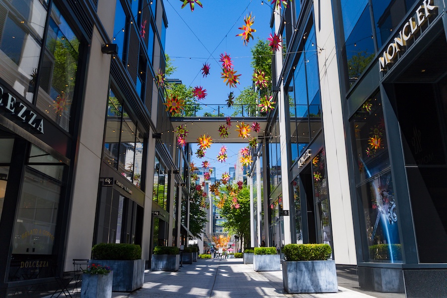 Colorful hanging flowers brighten the pedestrian walkway at CityCenterDC in Washington, DC.