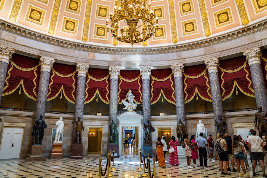 Visitors explore the ornate National Statuary Hall inside the U.S. Capitol.