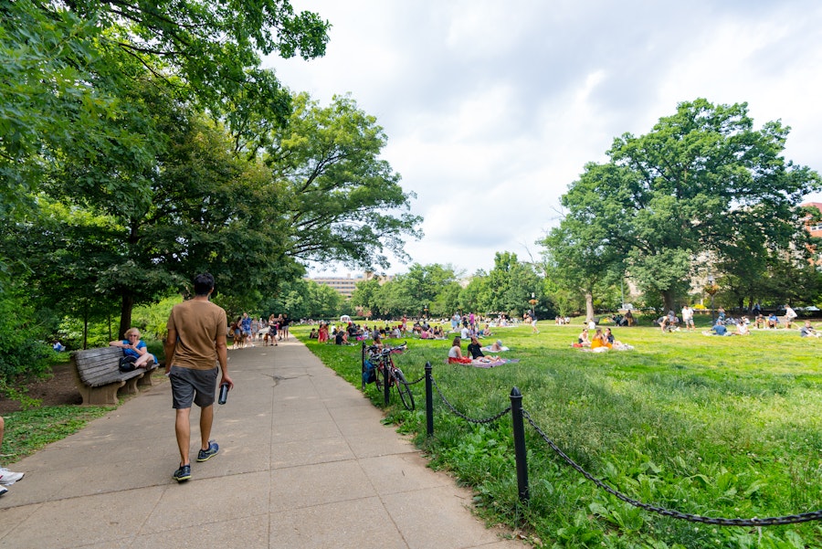 People enjoy picnics and strolls through Meridian Hill Park on a sunny day surrounded by trees and open lawns.
