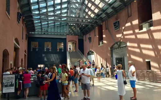 Visitors stand in the atrium of the United States Holocaust Memorial Museum in DC. 
